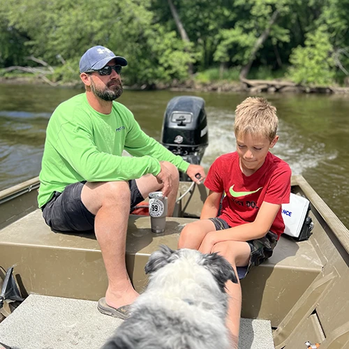 man in boat with boy