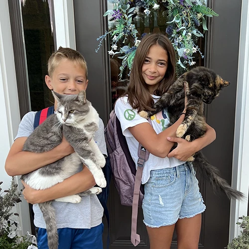kids holding cats